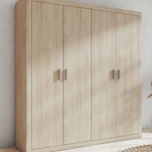Armario 4 puertas batientes modelo Lara de madera con acabado mate en un dormitorio luminoso.