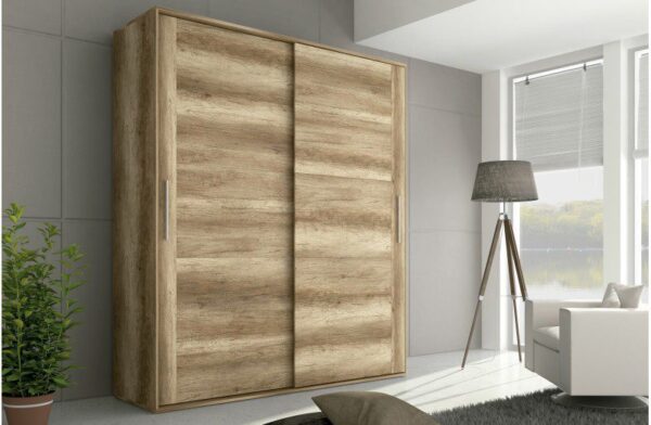 Armario con puertas correderas Chellén de melamina en color cañón instalado en un dormitorio moderno.