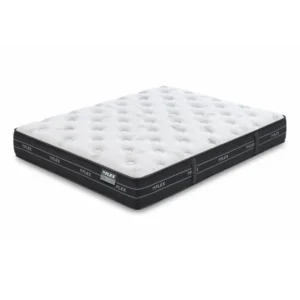 Colchón Nube Visco Flex de muelles ensacados y viscoelástica sobre una base tapizada en un dormitorio moderno y luminoso.