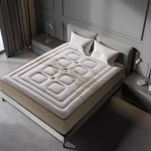 Colchón viscoelástico Premium sobre una base de cama en un dormitorio luminoso, mostrando su tejido acolchado y grosor.