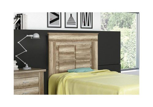 Vista frontal del cabecero juvenil Chellén color cañón, apoyado en sus patas, en una habitación moderna.